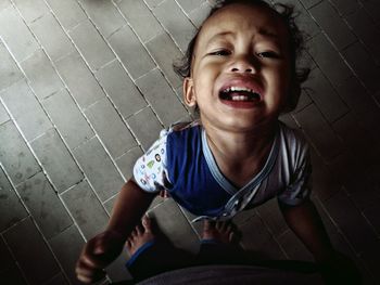 Portrait of smiling girl sitting outdoors