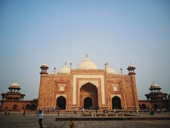 People in front of taj mahal against clear sky