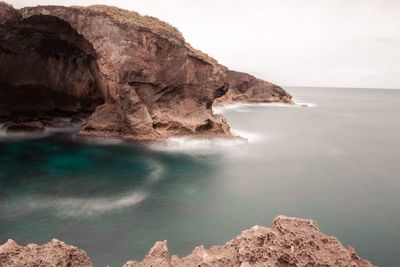 Scenic view of rock formation by sea