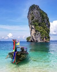 Scenic view of rock formation in sea against sky