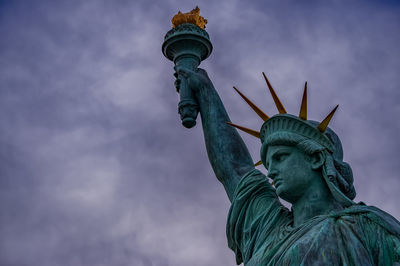 Low angle view of statue of liberty against sky