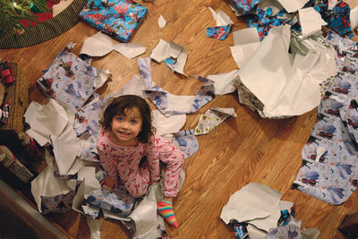 High angle view portrait of girl on floor at home