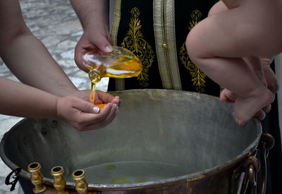 Midsection of child holding hands