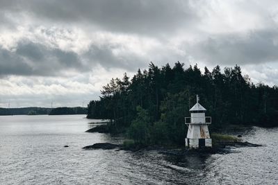 Scenic view of lake by building against sky