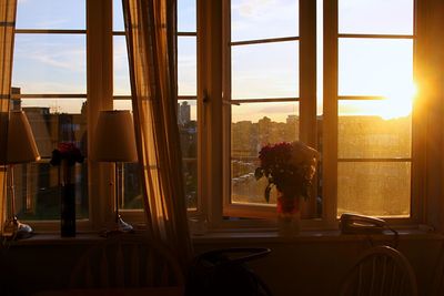 Man sitting in city seen through window