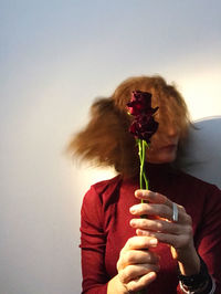 Woman turning her head holding flowers
