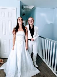 Portrait of bride with female friend at bridal shop