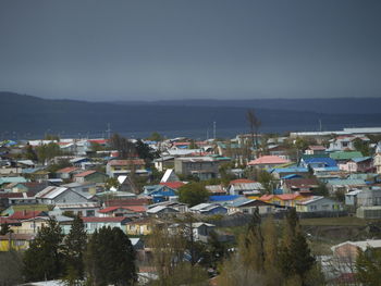 High angle view of townscape by sea against sky