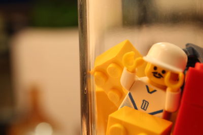Close-up of yellow toy on glass