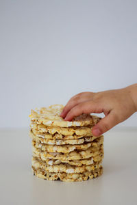 Hands of the child with puffed rice cakes