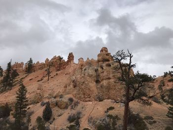 Low angle view of rock formation against sky