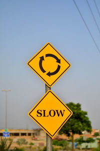 Close-up of road sign against clear sky