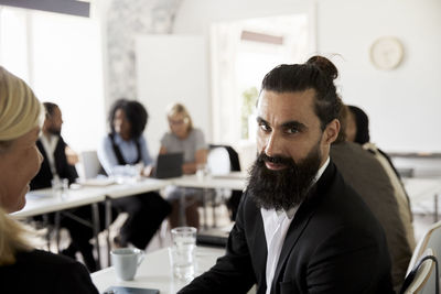 Side view of young man working in office