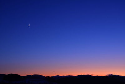 Scenic view of silhouette mountains against sky at night