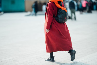 Rear view of woman walking on footpath