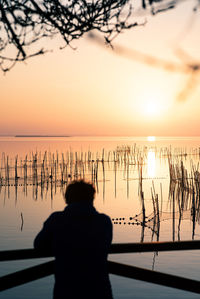 Man watching the sunset at valencia's albufera against the light
