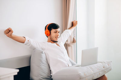 Young man using mobile phone at home