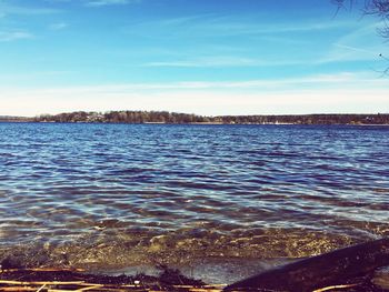 Scenic view of sea against blue sky