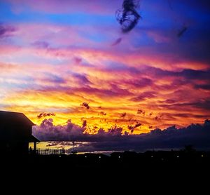 Silhouette of landscape against cloudy sky