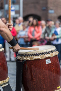 Close-up of man banging drum