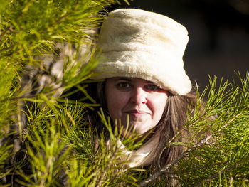 Portrait of woman by branch