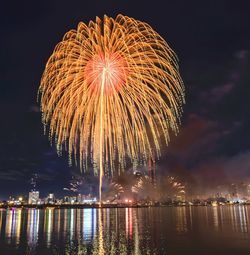 Low angle view of firework display at night