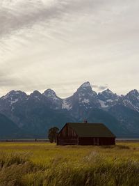 Scenic view of field and mountains against sky