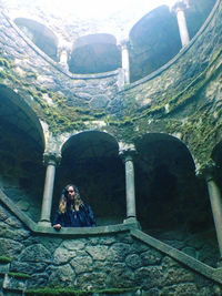Portrait of woman seen through archway