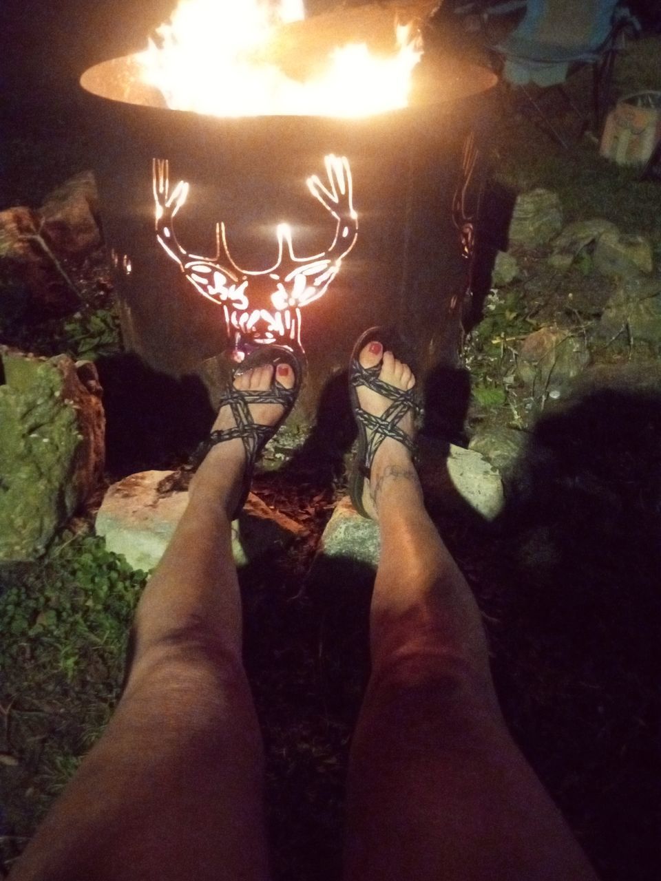 personal perspective, low section, one person, human leg, nature, lifestyles, limb, burning, leisure activity, fire, illuminated, glowing, flame, human limb, adult, hand, darkness, outdoors, standing, men, shoe