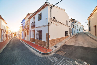 Street amidst buildings against sky in city