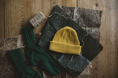 Knitted hat and socks on on wrapping paper