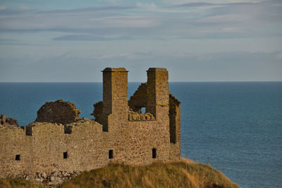 Castle by sea against sky