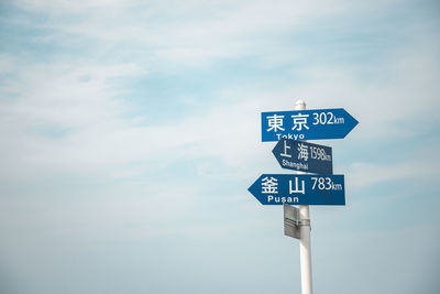 Low angle view of road sign against sky