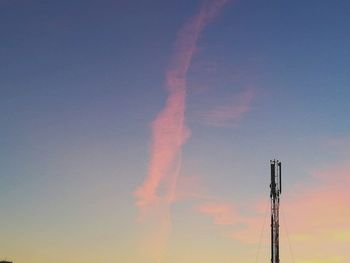 Low angle view of vapor trail against sky during sunset