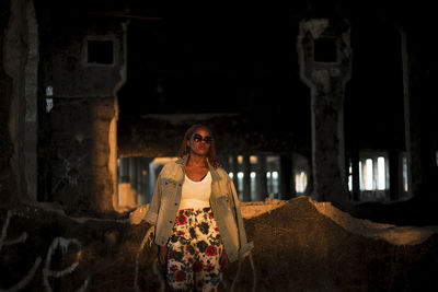 Portrait of woman standing at historical building