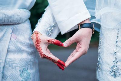 Close-up of couple holding hands