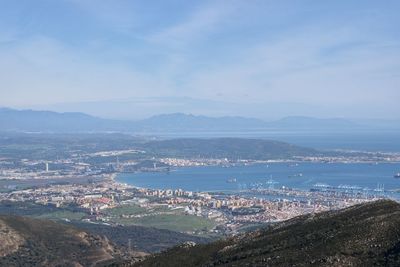 High angle view of townscape by sea against sky