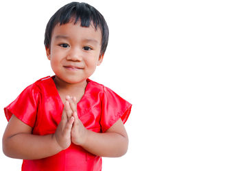 Portrait of cute boy against white background