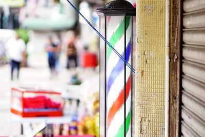 Close-up of multi colored flags hanging at market