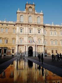 Group of people in front of building in modena