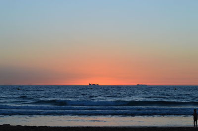 Scenic view of sea against clear sky during sunset