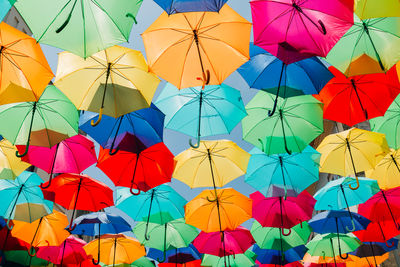 Low angle view of multi colored umbrellas hanging on clothesline