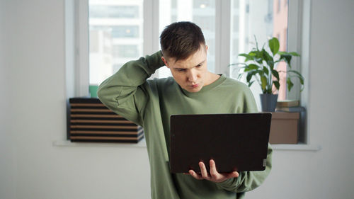 Man using mobile phone at home