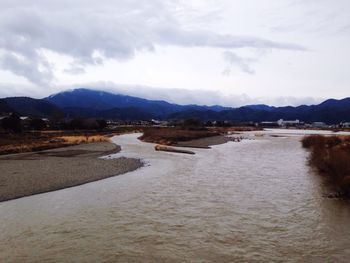 Scenic view of mountains against cloudy sky