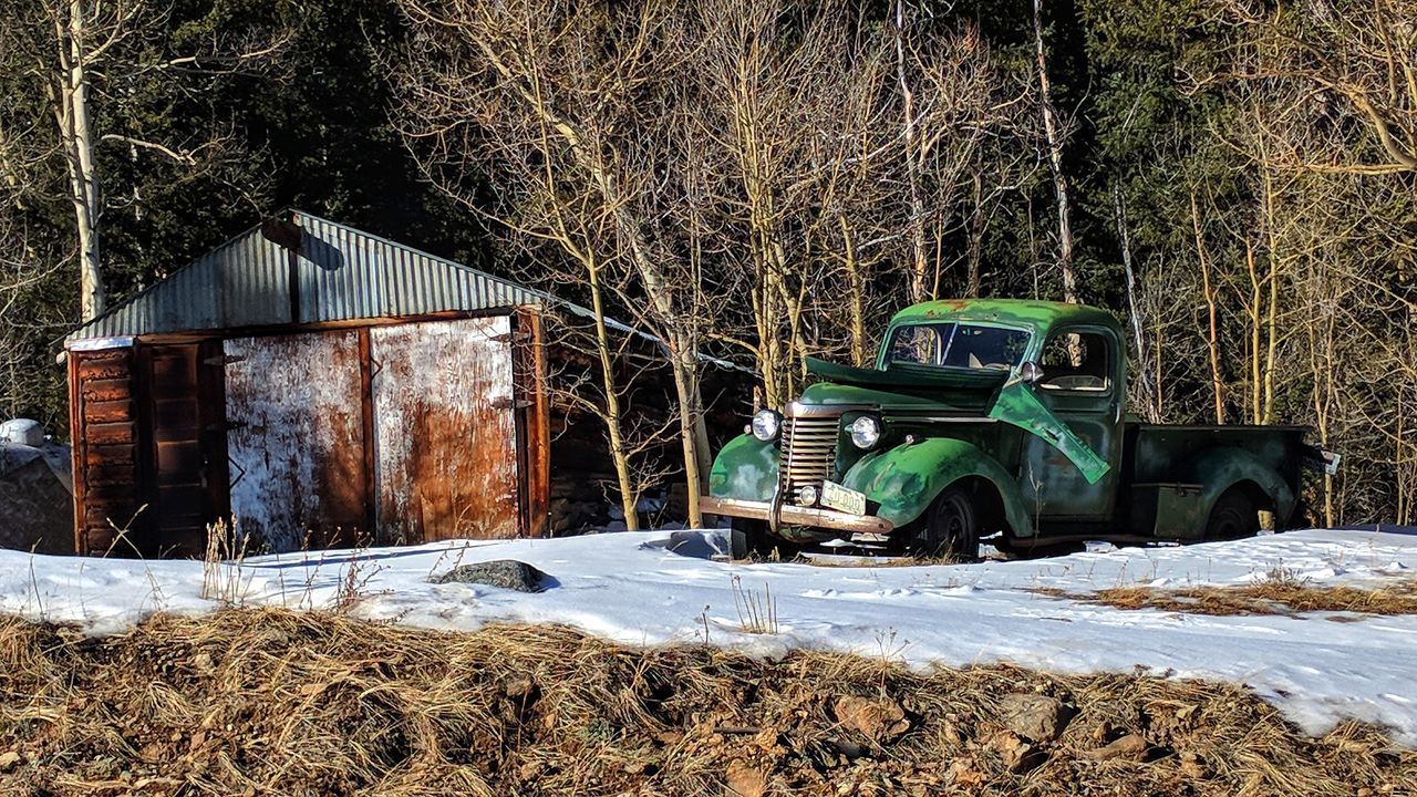 ABANDONED CARS ON SNOW FIELD