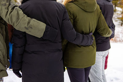 Rear view of man and woman standing against people