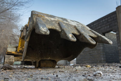 Abandoned excavator on the field against a clear sky