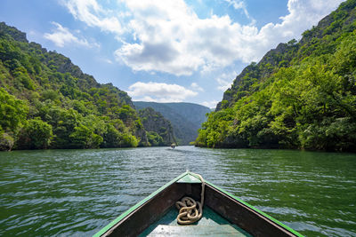 Scenic view of river amidst mountains against sky