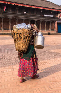 Woman carrying wicker basket