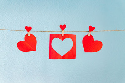 Close-up of red heart shape text on white wall